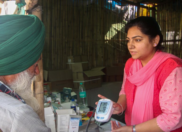 The free health clinic (left) that was set up for  farmers camping at the Tikri border site. Dr. Sakshi Pannu (in the pink dress) ran it every day since April