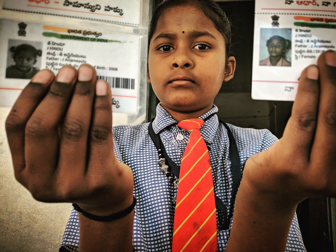 Girl shows Aadhar cards