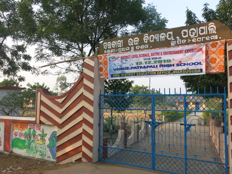 Left: The villagers say income from forest produce helped them build this high school in the village. Right: In a large clearing, under the watch of company staff, hundreds of freshly logged trees are piled up