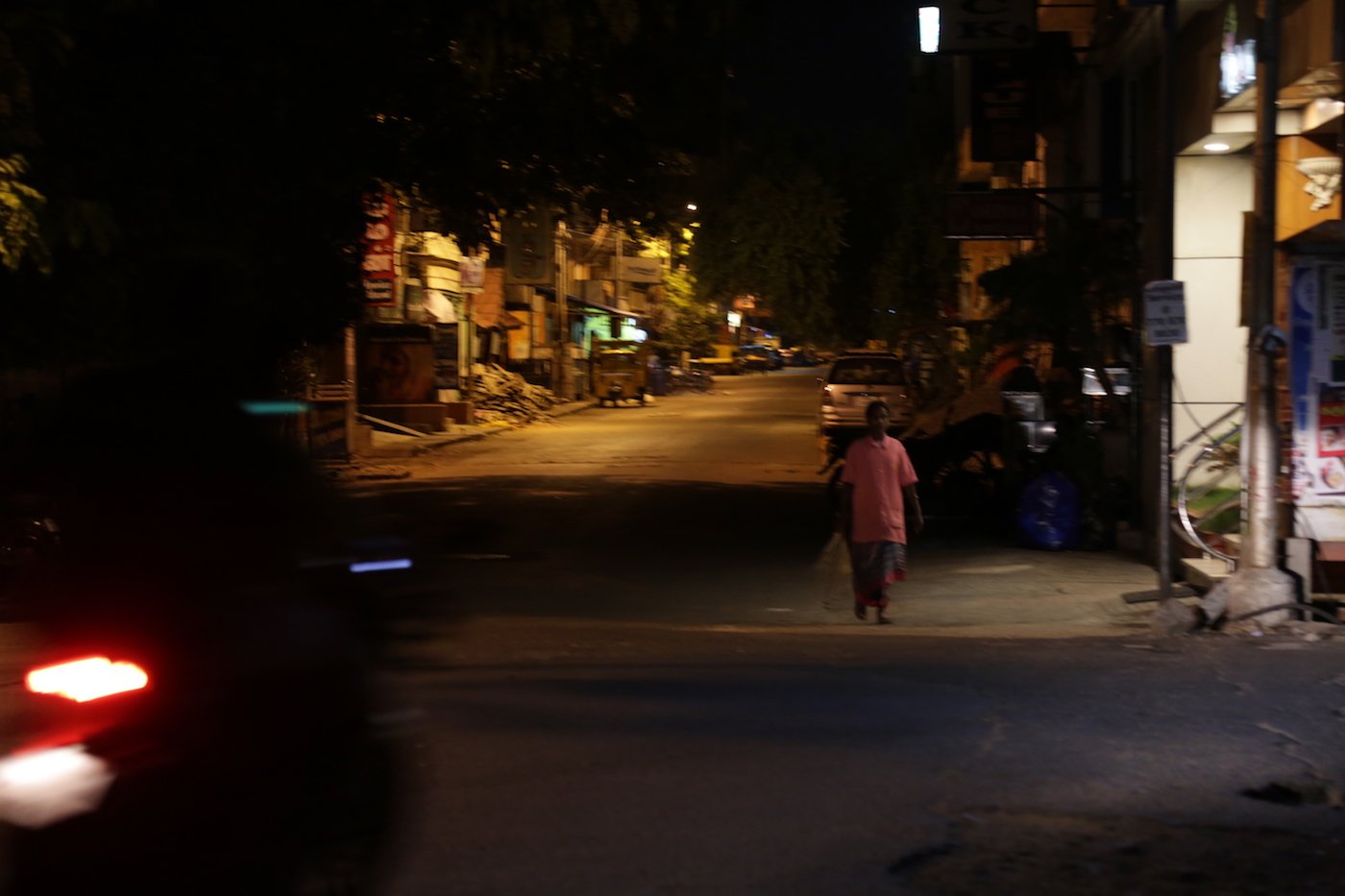 A sanitation worker pauses on the road she has just cleaned