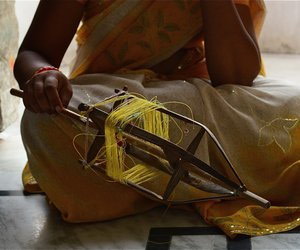 Woman adding thread to spindle