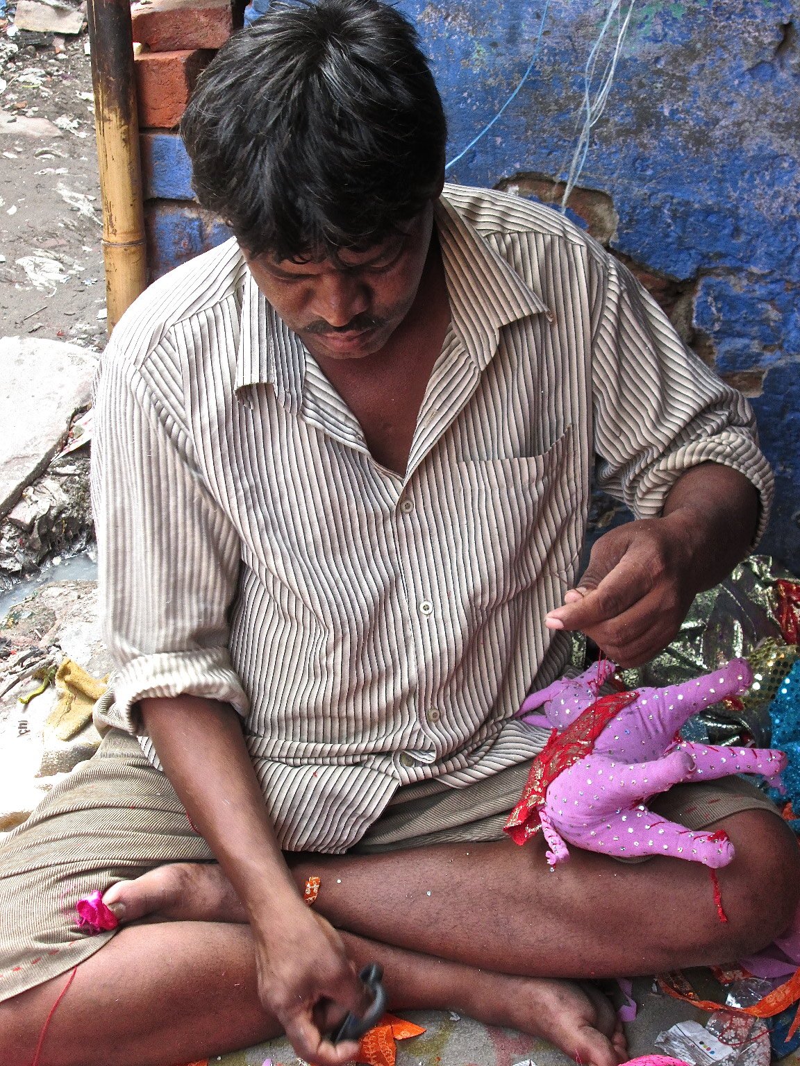 Man making puppets in Delhi's Kathputli Colony
