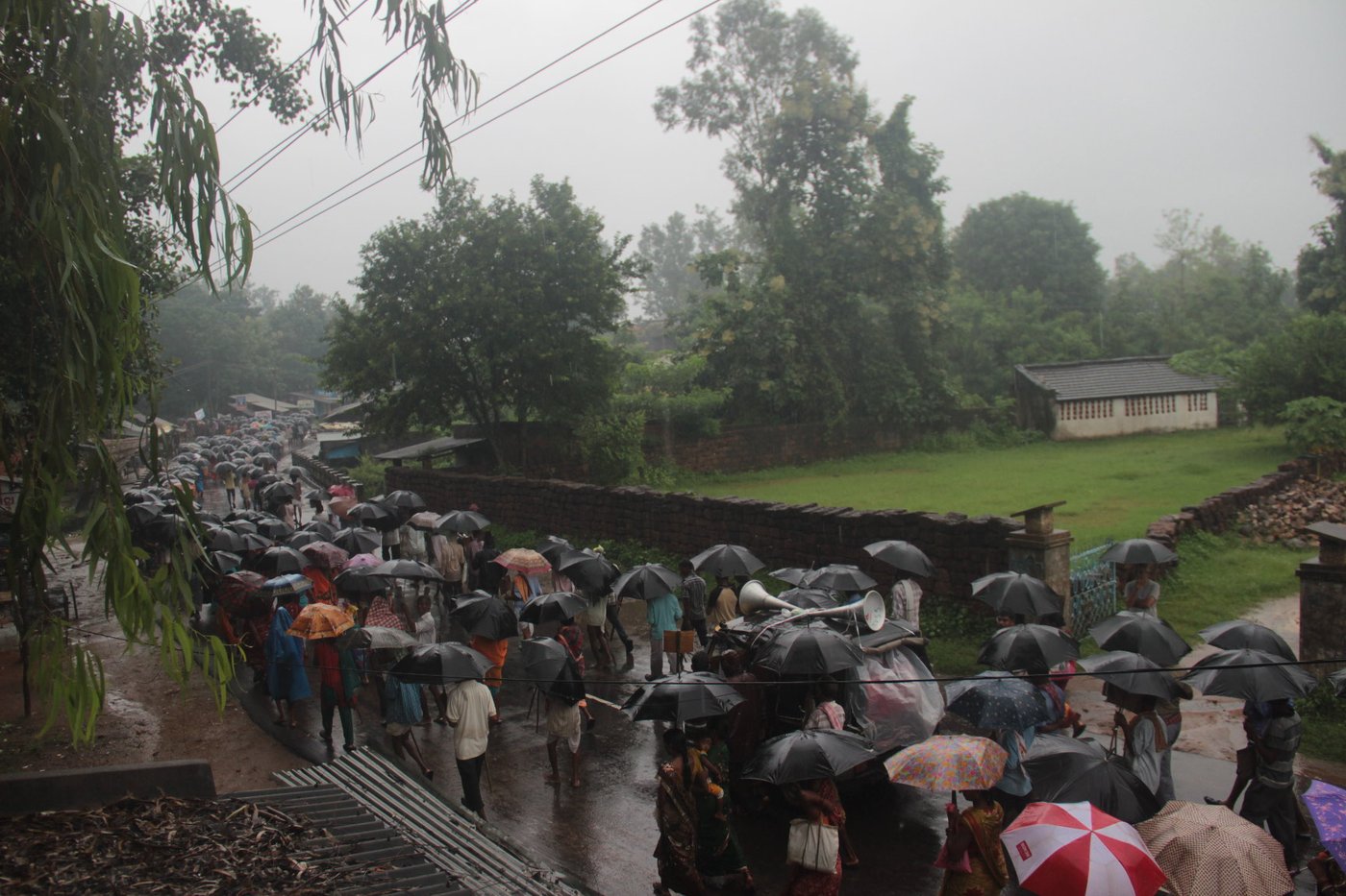 Group of people marching on rainy day