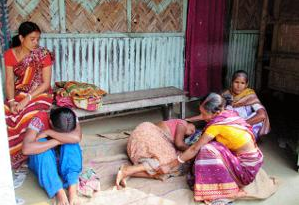 Two women being consoled by others